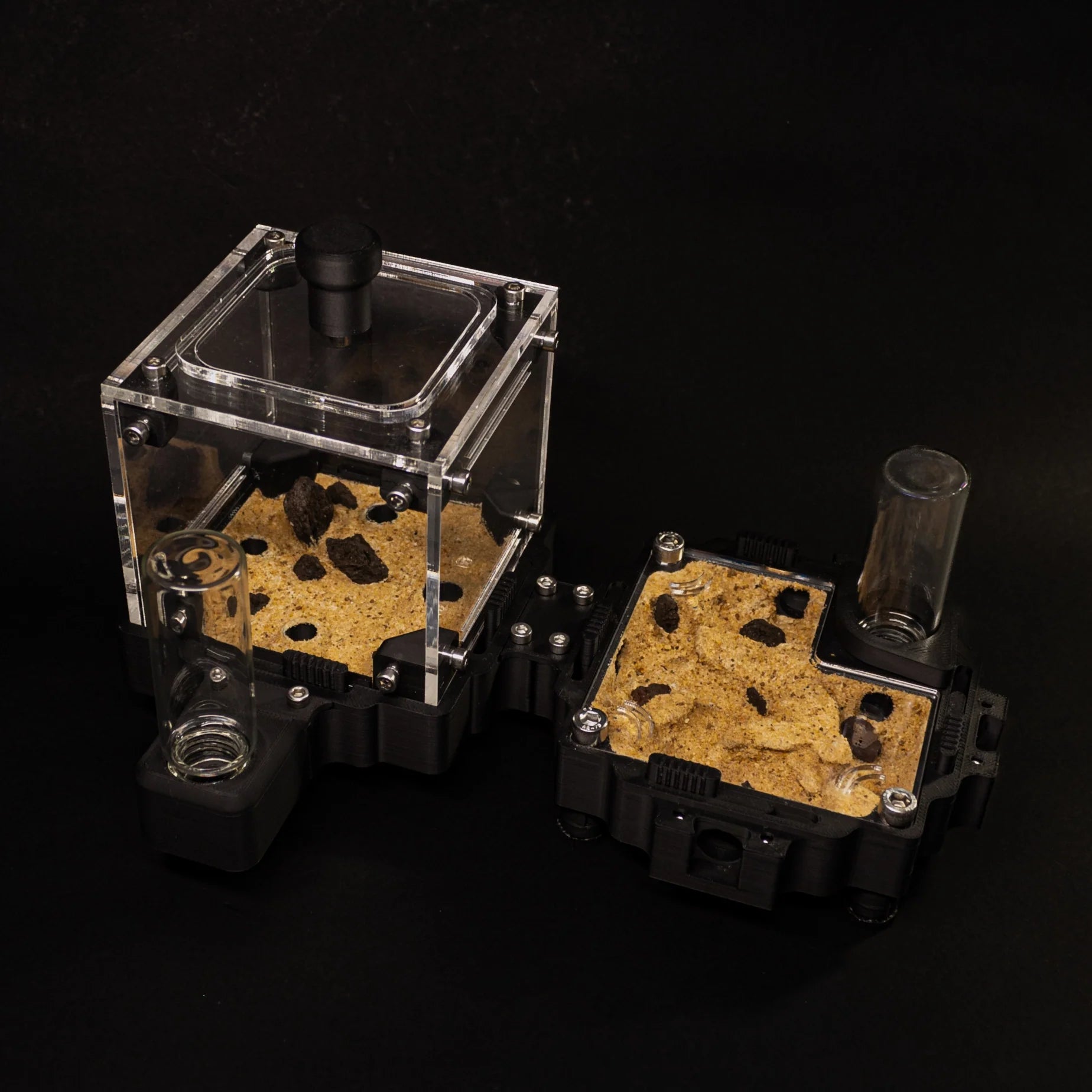 Translucent ant farm kit with sandy substrate and transparent tubes, perfect for observing ant behavior.