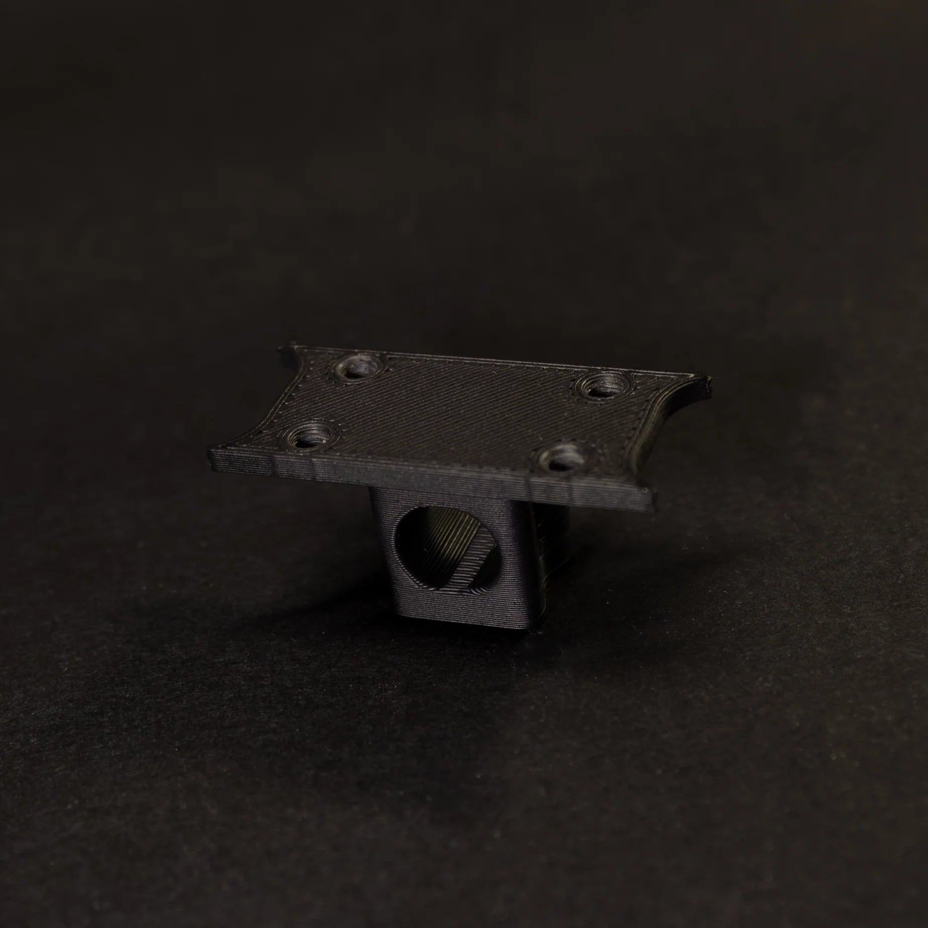 Black rubber block accessory with a hole, ideal for various DIY projects and repairs.